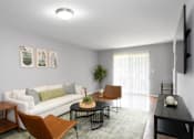 Thumbnail 11 of 81 - A living room with a white couch, a brown chair, a black table, and a flat-screen TV mounted on the wall.