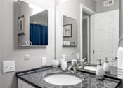 Thumbnail 77 of 81 - A bathroom with a sink, mirror, and towel.