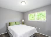 Thumbnail 20 of 81 - A bedroom with a white bed and green pillows.