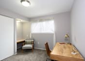 Thumbnail 23 of 81 - A room with a desk and chairs.