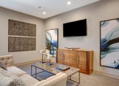 Thumbnail 34 of 54 - a living room with a couch and a television at Villages at Morgan Metro, Landover