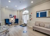 Thumbnail 12 of 18 - Resident lobby with seating and entrance at Park at Winterset Apartments, Owings Mills, MD 21117