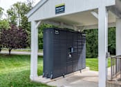 Thumbnail 15 of 18 - Package locker station under covered shelter at Park at Winterset Apartments, Owings Mills, MD