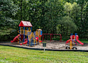 Thumbnail 18 of 18 - Playground with slides and climbing structures at Park at Winterset Apartments, Owings Mills, Maryland