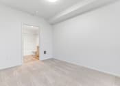 Thumbnail 26 of 26 - A room with a white door and a light on the wall.