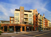 Thumbnail 1 of 26 - A street view of a row of modern buildings.