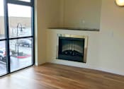 Thumbnail 23 of 26 - A room with a fireplace and sliding glass doors.