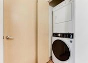 Thumbnail 19 of 26 - A white dryer is in a small room.