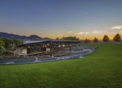 Thumbnail 5 of 6 - a view of a stadium at sunset with mountains in the background