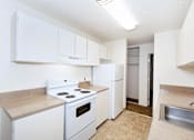 Thumbnail 33 of 47 - A kitchen with white appliances and cabinets.