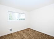 Thumbnail 24 of 47 - A room with a window and a carpeted floor.