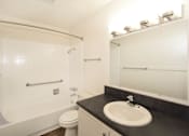 Thumbnail 23 of 47 - A bathroom with a toilet, sink, and shower.