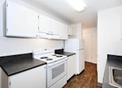 Thumbnail 20 of 47 - A kitchen with white appliances and cabinets.