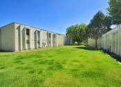 Thumbnail 21 of 48 - an old white building with green grass and trees