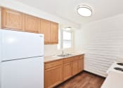 Thumbnail 38 of 48 - a small kitchen with white appliances and wooden cabinets