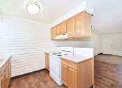 Thumbnail 35 of 48 - an empty kitchen with white appliances and wooden cabinets