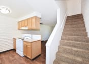 Thumbnail 34 of 48 - a kitchen with a stove and a staircase in a house