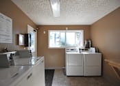 Thumbnail 14 of 47 - a kitchen with a washer and dryer and a window