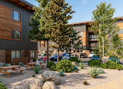 Thumbnail 1 of 9 - A modern building with wooden accents and a landscaped courtyard.