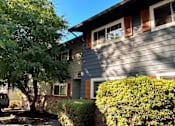 Thumbnail 5 of 47 - A house with a grey siding and red window trim.