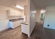 Thumbnail 41 of 47 - A kitchen with white cabinets and a countertop.