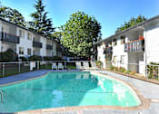 Thumbnail 47 of 47 - a large swimming pool in front of an apartment building