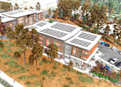 Thumbnail 4 of 9 - A building with a brown roof and orange walls is surrounded by trees.