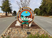 Thumbnail 6 of 7 - A welcome sign for the City of Scotts Valley is displayed in front of a road.