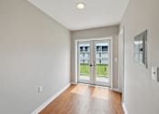 Thumbnail 24 of 25 - A room with a sliding glass door leading to a balcony.