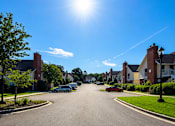 Thumbnail 13 of 18 - A sunny day on a residential street with houses on both sides.