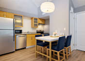 Thumbnail 4 of 18 - A kitchen with a table and chairs.