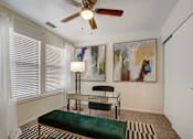 Thumbnail 10 of 32 - A room with a green bench and a painting on the wall.