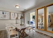 Thumbnail 5 of 32 - A dining room with a table and chairs.