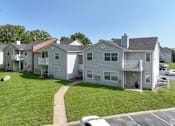 Thumbnail 26 of 29 - A row of houses with a car parked in front at Sedgefield Square Apartments, Greensboro, NC