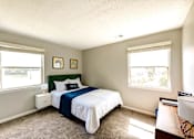 Thumbnail 9 of 29 - A bedroom with a bed, nightstand, and window at Sedgefield Square Apartments, Greensboro, NC