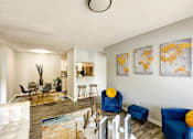 Thumbnail 3 of 29 - A living room with a white couch and blue chairs at Sedgefield Square Apartments, Greensboro, North Carolina
