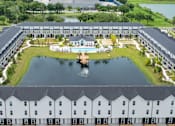 Thumbnail 1 of 45 - A large white building with a pool in the middle of it.