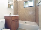 Thumbnail 8 of 16 - a bathroom with a toilet sink and bathtub at Willow Gardens Apartments, New Jersey