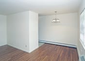 Thumbnail 12 of 16 - a bedroom with hardwood floors and a chandelier at Willow Gardens Apartments, Teaneck
