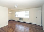 Thumbnail 11 of 16 - a bedroom with hardwood floors and white walls at Willow Gardens Apartments, Teaneck, 07666