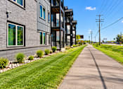 Thumbnail 70 of 71 - A long, narrow road runs between two buildings.