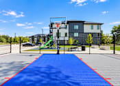 Thumbnail 61 of 71 - A basketball court with a blue surface and red boundary lines.