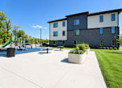 Thumbnail 63 of 71 - A large building with a playground in front of it.