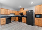 Thumbnail 13 of 22 - a kitchen with black appliances and wooden cabinets