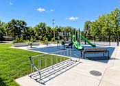 Thumbnail 64 of 71 - A playground with a slide and a bench.