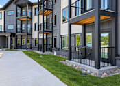 Thumbnail 14 of 71 - A modern apartment building with balconies and railings.