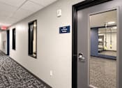 Thumbnail 15 of 71 - A hallway leading to a fitness room.