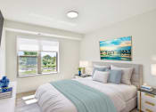 Thumbnail 4 of 4 - A bedroom with a large bed and a painting on the wall.