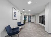 Thumbnail 3 of 22 - a corridor with two chairs and a table in a building