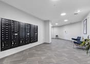 Thumbnail 4 of 22 - a large locker room in a room with white walls and tile flooring
